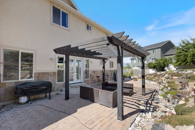 View of patio featuring french doors, area for grilling, a pergola, and outdoor lounge area | Image 31