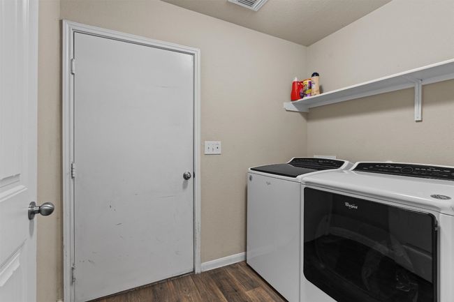 Laundry area with independent washer and dryer and dark wood-style floors | Image 22