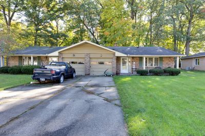 Single story home with a front lawn and a garage | Image 1