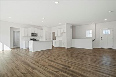 Unfurnished living room featuring dark hardwood / wood-style floors | Image 2