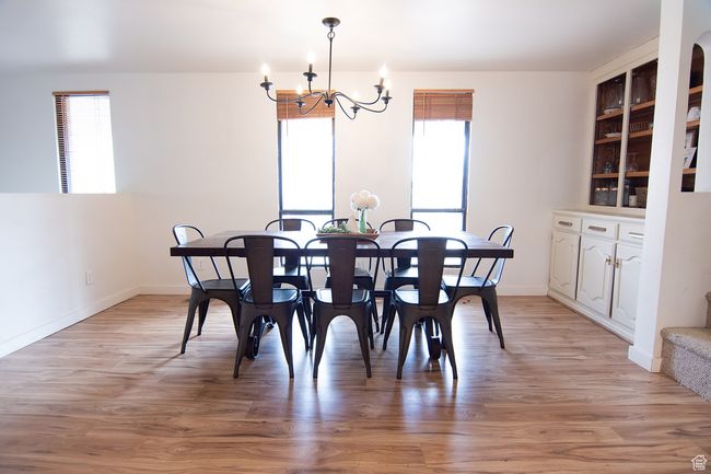 Dining area with plenty of natural light, a chandelier, and light wood finished floors | Image 5