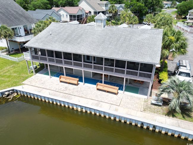 Rear view of property with a patio, roof with shingles, and a water view | Image 30