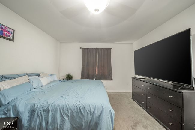 bedroom featuring light carpet and baseboards | Image 17