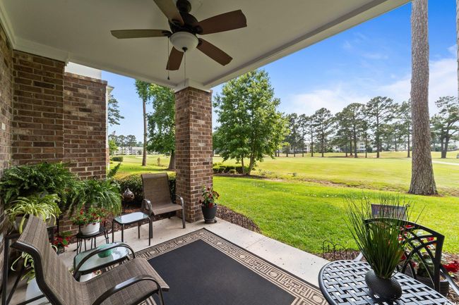 View of patio featuring ceiling fan and golf course view | Image 14