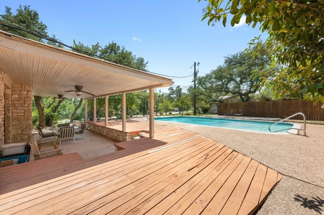 View of pool featuring a ceiling fan, a patio, and privacy fence | Image 23