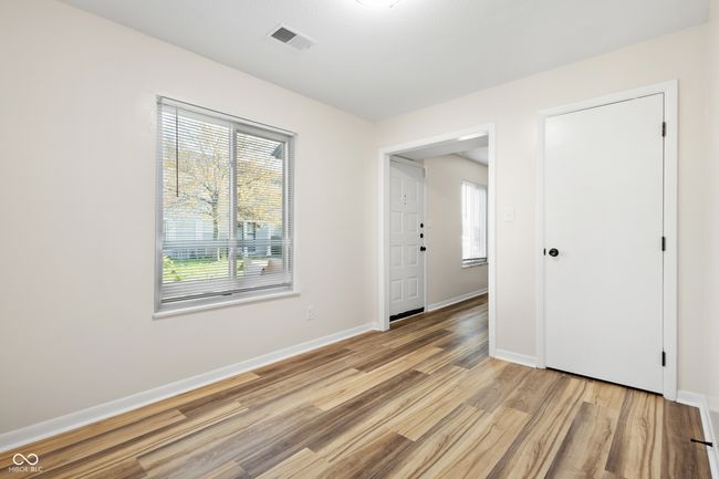 empty room with baseboards, visible vents, and light wood-style floors | Image 9