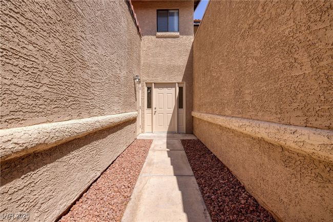 Doorway to property featuring stucco siding | Image 27