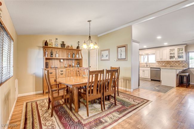 Dining area featuring a chandelier, light wood finished floors, and recessed lighting | Image 26