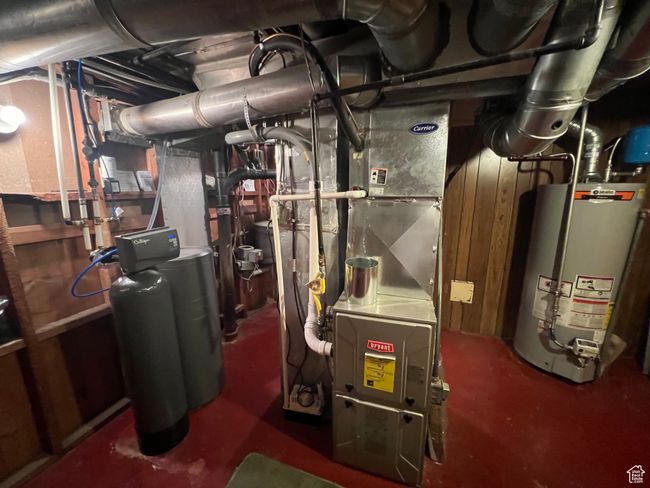 Utility room featuring water heater, Central Vac, Water Softener, Sprinkler connections, 2 storage areas, cold storage. | Image 18