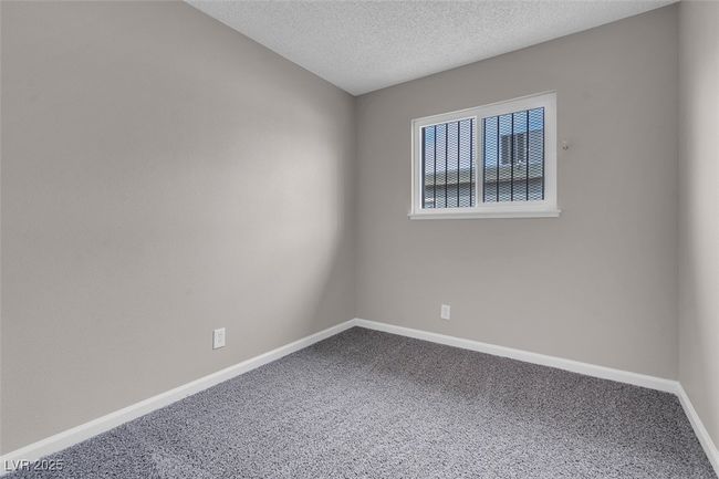 Empty room with baseboards, carpet flooring, and a textured ceiling | Image 25
