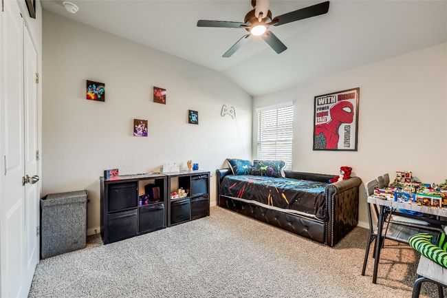 Bedroom with lofted ceiling, carpet flooring, baseboards, and a ceiling fan | Image 24