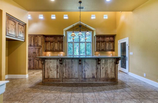 Kitchen with high ceilings and natural light. | Image 11