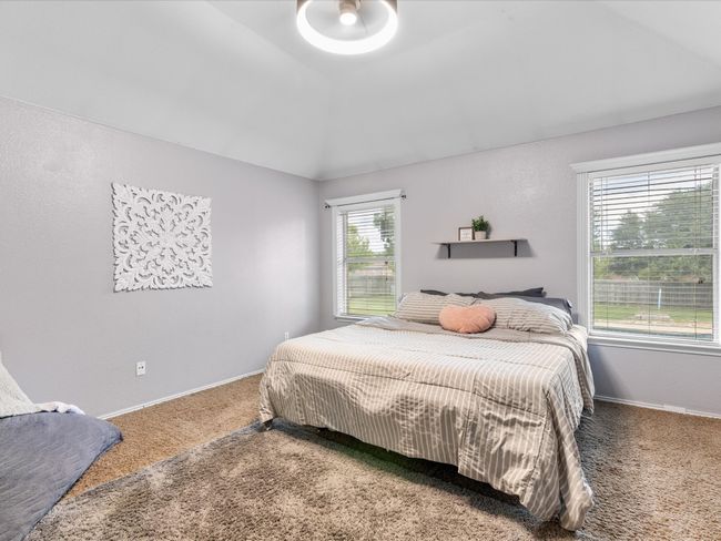 Carpeted bedroom featuring lofted ceiling and baseboards | Image 16