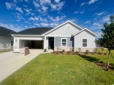 Exterior space featuring a garage and a lawn | Image 1