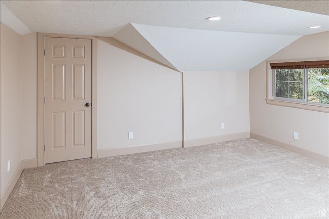 Bonus room featuring vaulted ceiling, a textured ceiling, carpet, and recessed lighting | Image 40