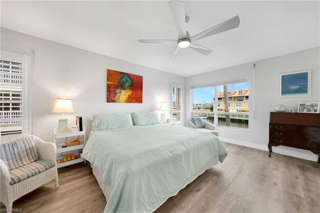 Bedroom with light wood-type flooring and ceiling fan | Image 21