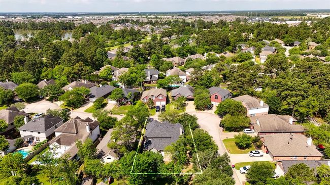 This aerial view captures the home’s prime corner lot location within Windrose, with the lush golf course visible in the distance. It offers a clear sense of space and proximity to the community's desirable amenities. | Image 38