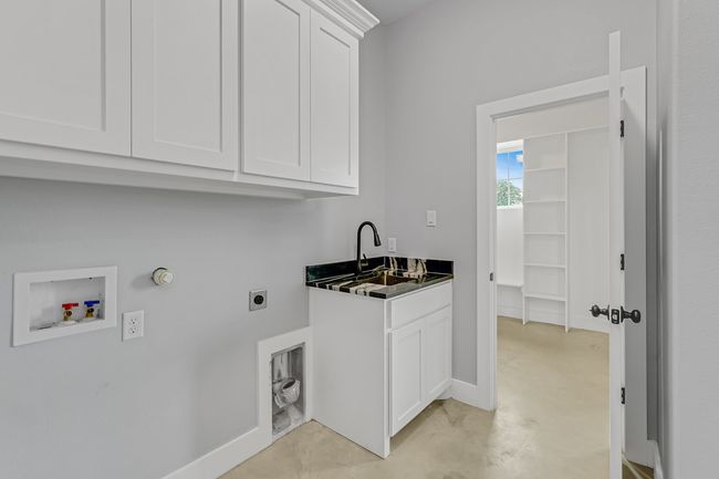 Laundry room with cabinet space, washer hookup, electric dryer hookup, baseboards, and hookup for a gas dryer | Image 23