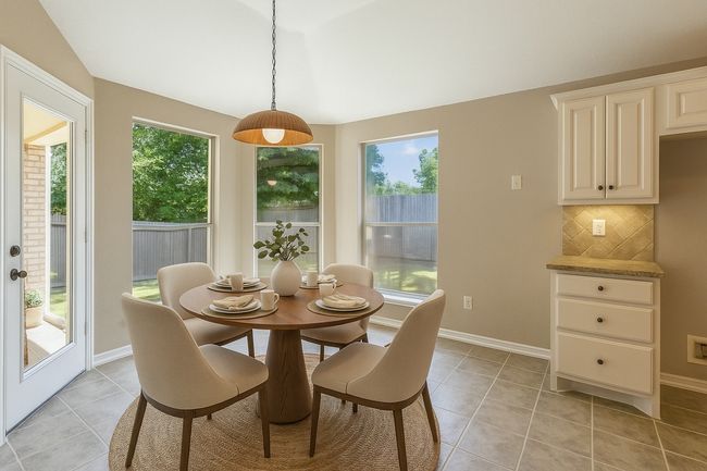 Dining area featuring baseboards, a wealth of natural light, and light tile patterned floors | Image 12