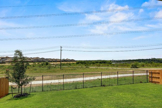 View of wrought iron fenced backyard facing g greenbelt, lake, neighborhood trails connecting to amenities | Image 35