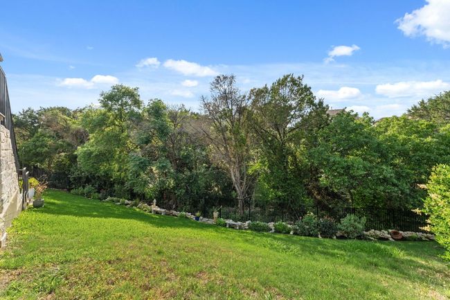 View of yard with fence and a wooded view | Image 24