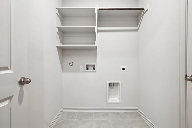 Laundry area featuring gas dryer hookup, washer hookup, hookup for an electric dryer, and tile patterned flooring | Image 31