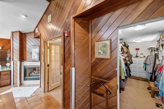 Corridor featuring light tile patterned flooring and wood walls | Image 21