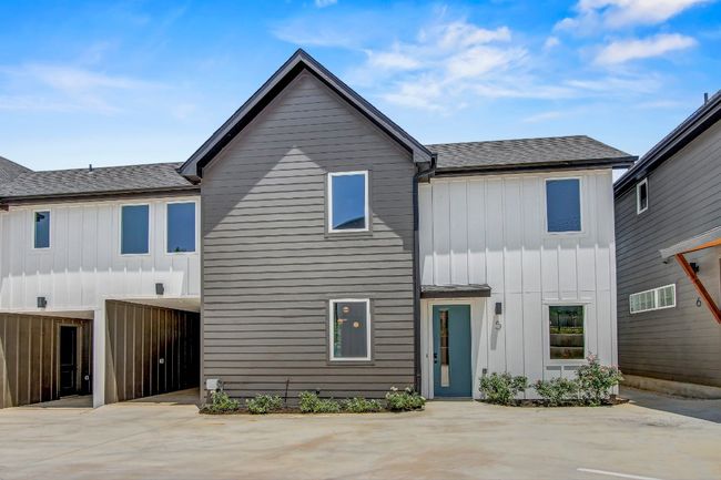 View of front facade with board and batten siding and roof with shingles | Image 30