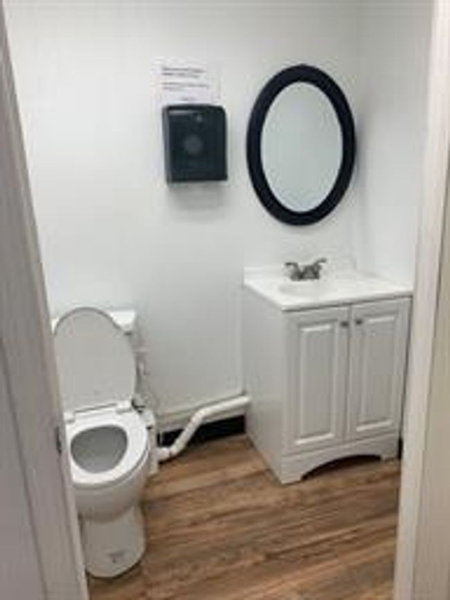 Bathroom with vanity, toilet, and wood finished floors | Image 6