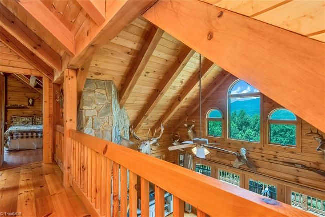 The upper-level full bathroom enhances convenience and comfort for residents and guests, providing a well-appointed space within the rustic charm of the log cabin. | Image 38