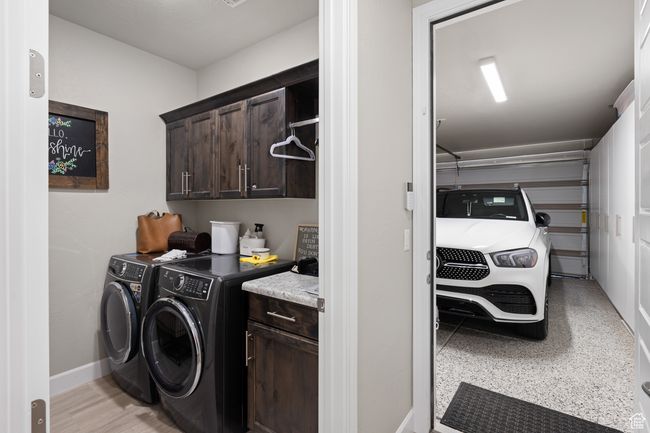 Washroom with cabinet space and washer and dryer | Image 43
