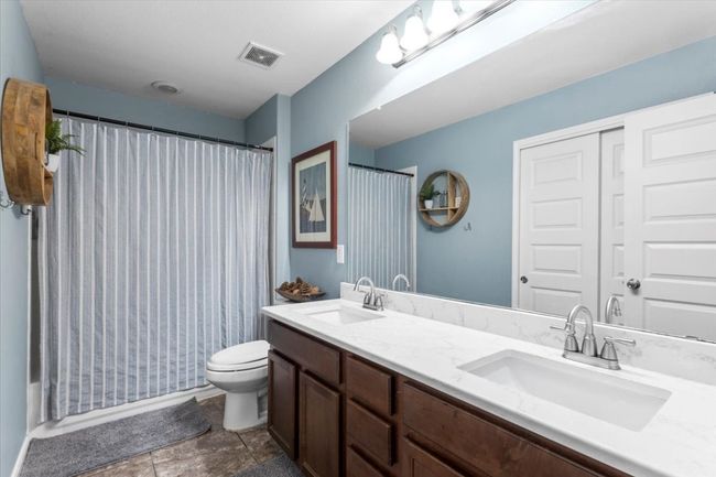 Bathroom featuring double vanity and toilet | Image 22