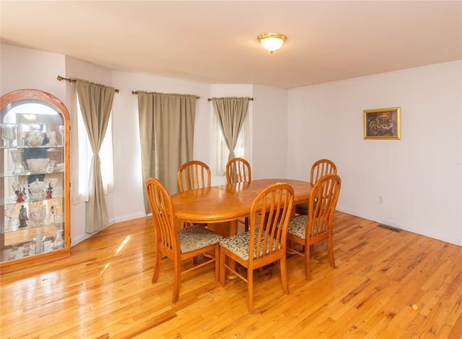 Dining room featuring light wood-type flooring, baseboards, and visible vents | Image 21