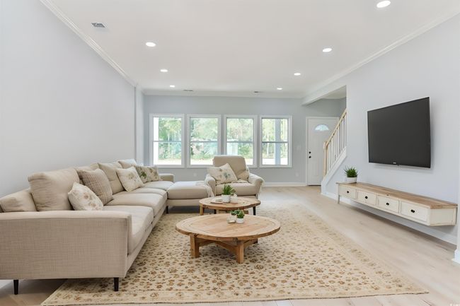 Living room with crown molding and light hardwood / wood-style flooring | Image 4
