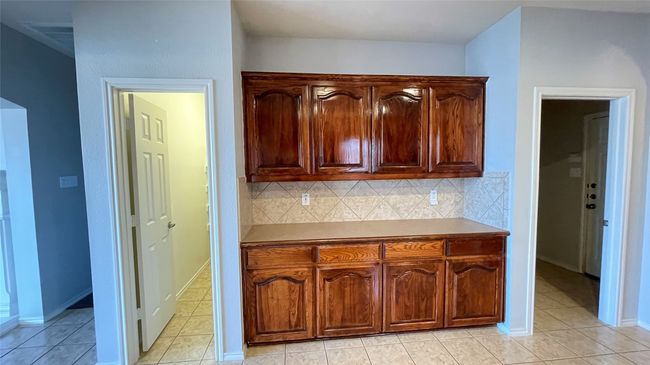 Kitchen with decorative backsplash and light tile patterned floors | Image 10