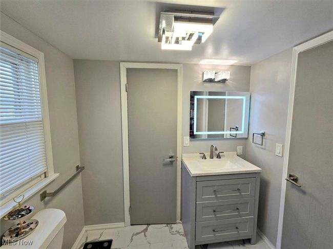 Bathroom with vanity, baseboards, and marble finish floor | Image 37