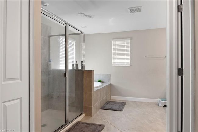Full bath with a bath, a stall shower, and plenty of natural light | Image 21