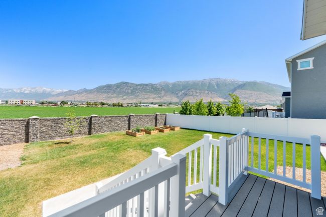 Wooden deck featuring a mountain view and a fenced backyard | Image 37