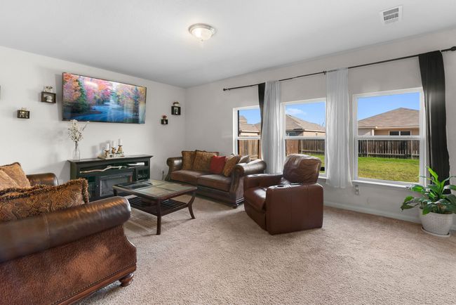 Living room with carpet floors and visible vents | Image 16