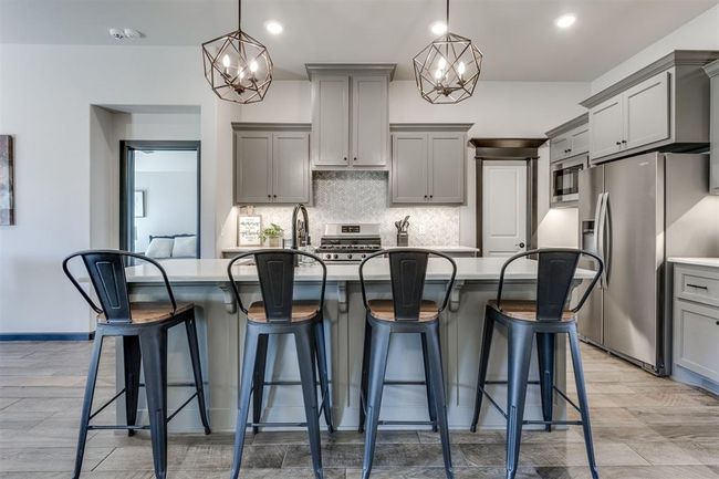 Kitchen with backsplash, gray cabinetry, stainless steel appliances, and light countertops | Image 38