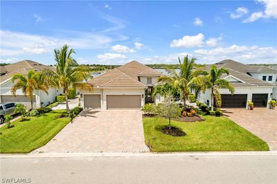 Mediterranean / spanish-style house with a garage and a front yard | Image 3