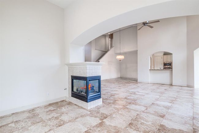 Enjoy this cozy fireplace from two areas in this spacious open living area. Neutrally decorated to a high standard throughout. | Image 23