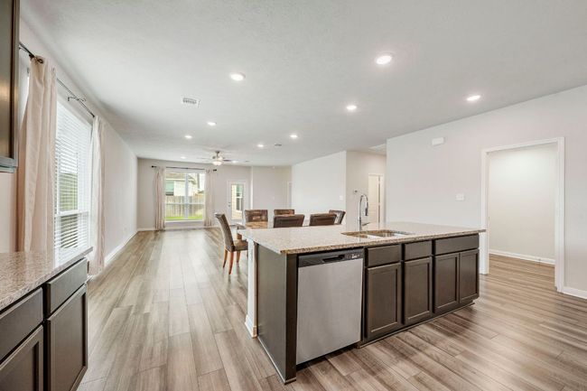 Kitchen overlooks living and dining spaces, allowing connection across the heart of the home. | Image 8