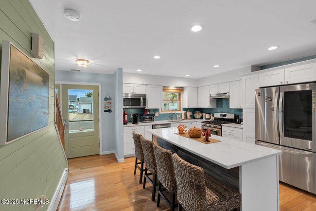 View from living room of entry way and eat in kitchen | Image 4