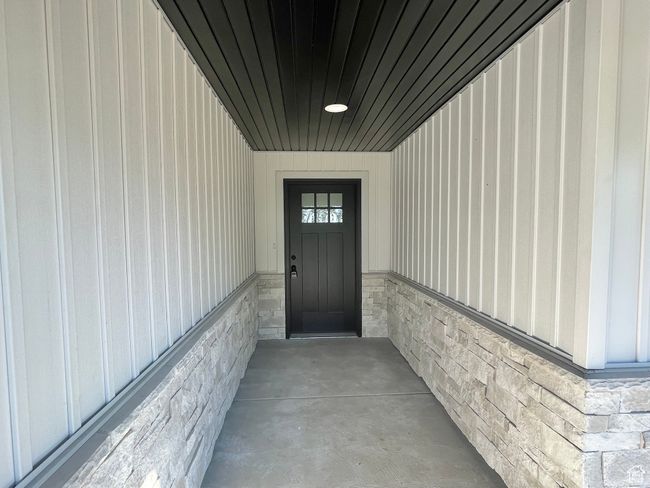 View of exterior entry featuring stone siding | Image 4