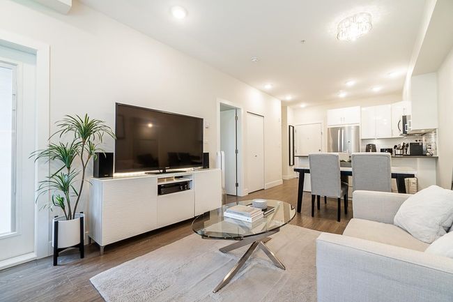Living area with wood finished floors and recessed lighting | Image 11