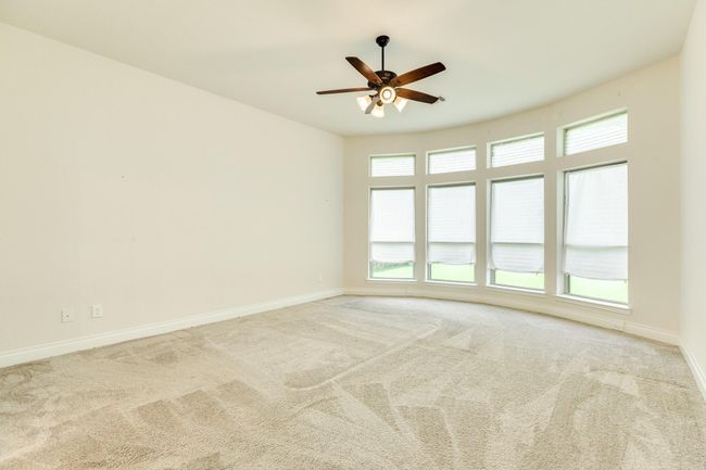 Primary bedroom with floor-to-ceiling windows overlooking the waterfront. This spacious area offers an incredible view. | Image 30
