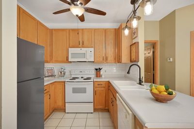 Updated light fixtures and faucet in this nice-sized kitchen. | Image 3