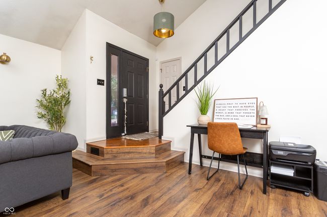 foyer entrance featuring wood finished floors, stairs, and vaulted ceiling | Image 4
