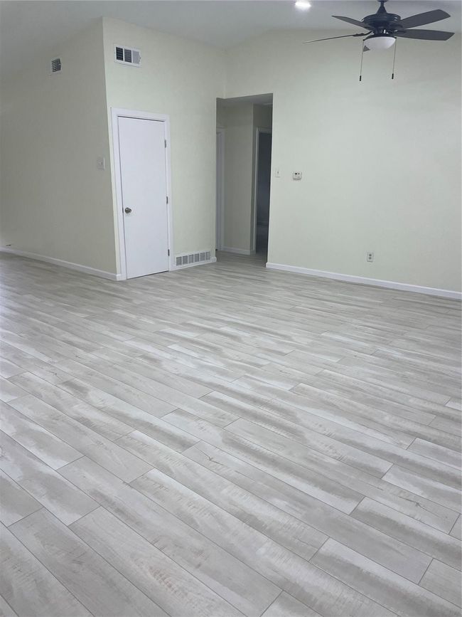 Empty room featuring a ceiling fan, baseboards, and light wood-style flooring | Image 23